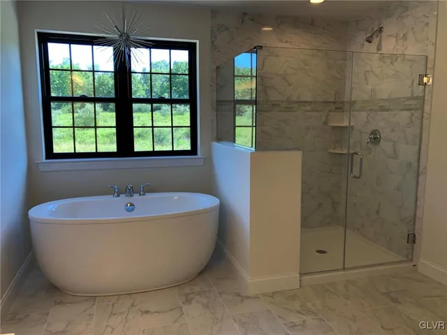 a bathroom with a bathtub and shower