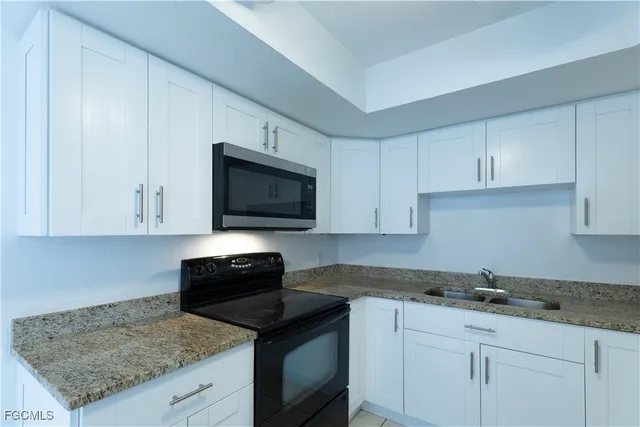a kitchen with a sink and refrigerator