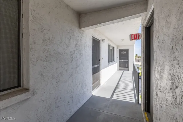 a view of a hallway with wooden cabinets