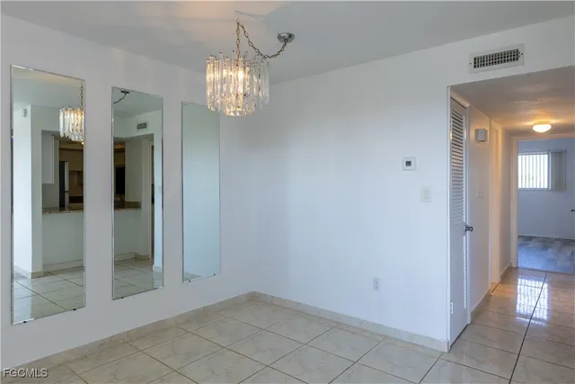 an empty room that has a chandelier in it