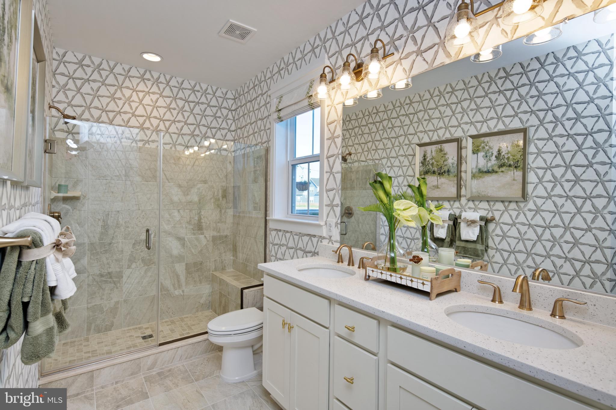 1007 Champlain Court Trappe, MD 21673 - Photo 11 of 54 a bathroom with a double vanity sink toilet and shower