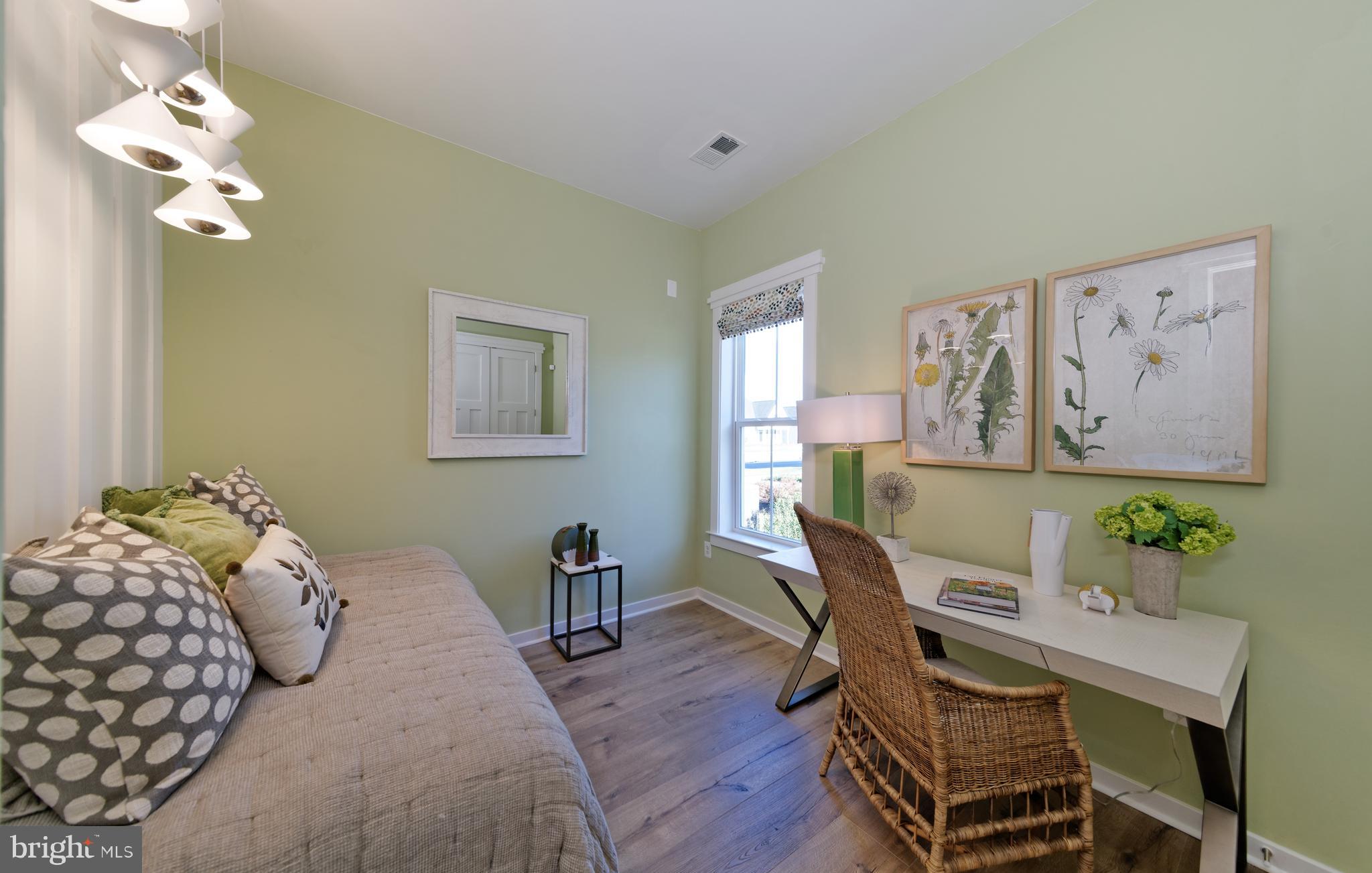 1007 Champlain Court Trappe, MD 21673 - Photo 16 of 54 a bedroom with a bed table chair and a window