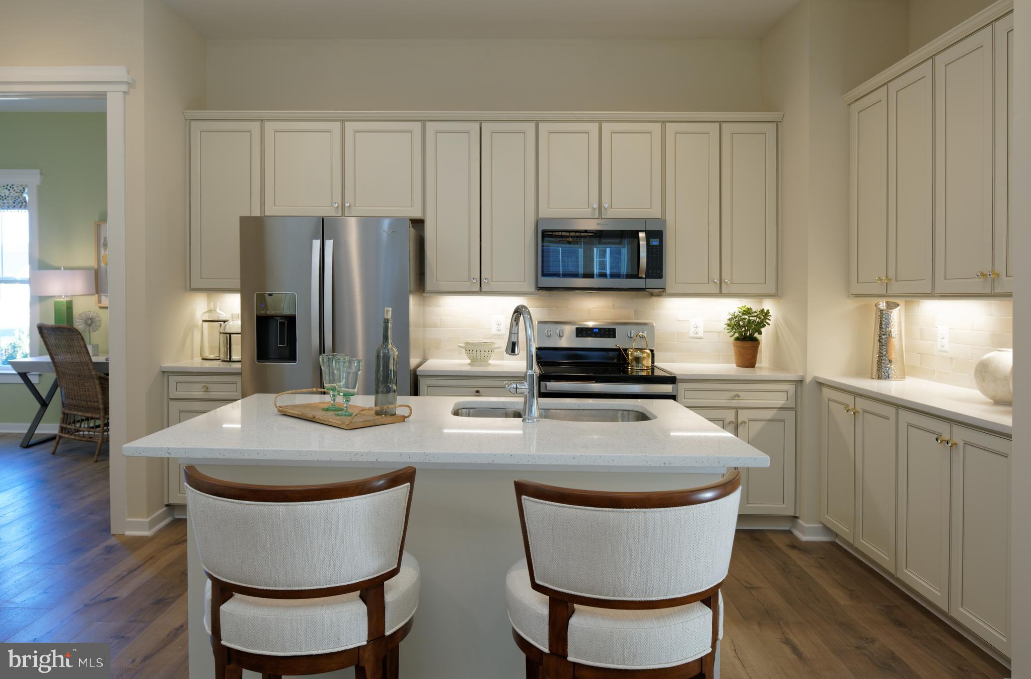 1007 Champlain Court Trappe, MD 21673 - Photo 5 of 54 a kitchen with stainless steel appliances granite countertop a table chairs stove and refrigerator