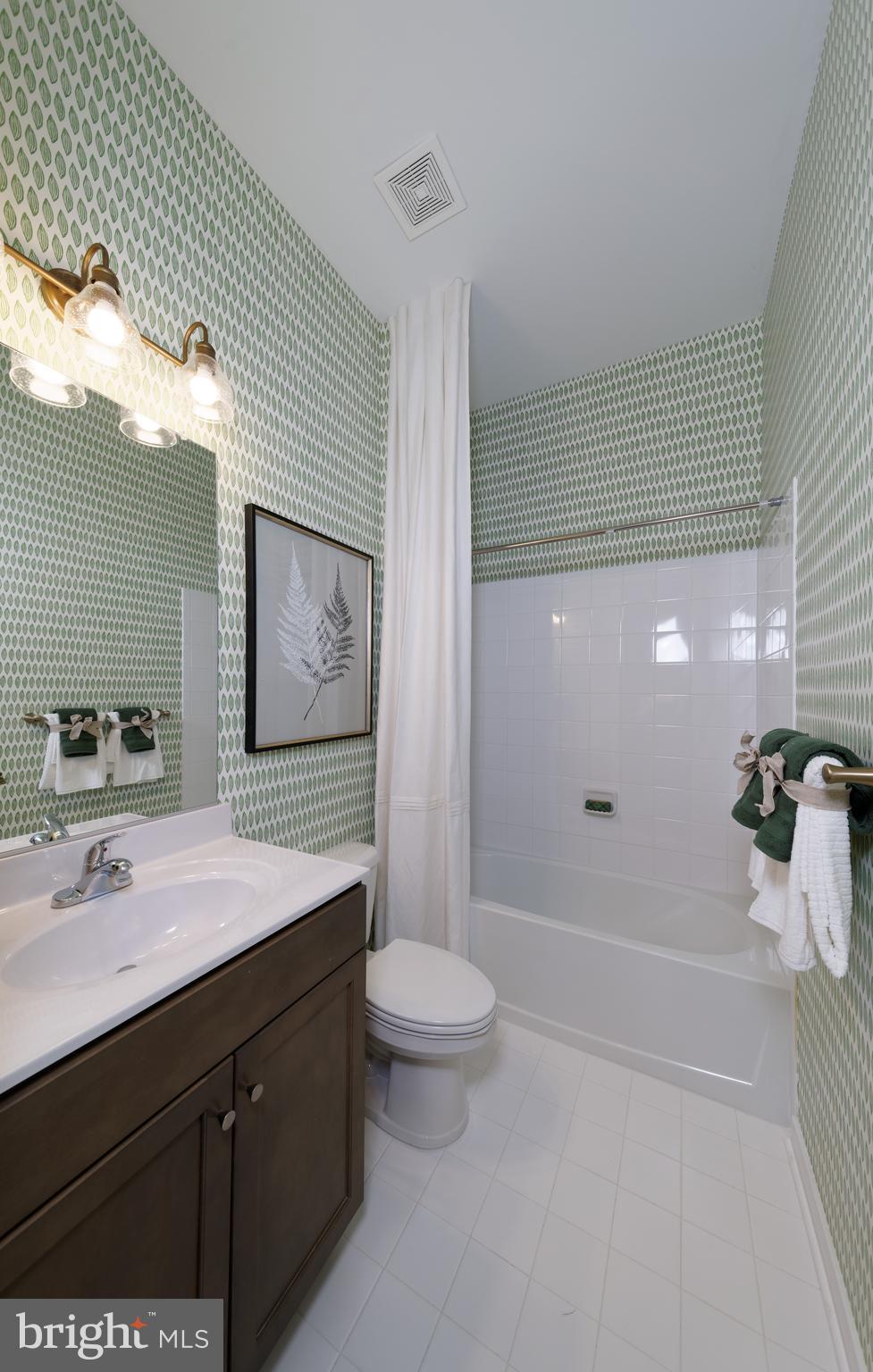 1007 Champlain Court Trappe, MD 21673 - Photo 7 of 54 a spacious bathroom with a granite countertop sink a toilet a mirror and shower