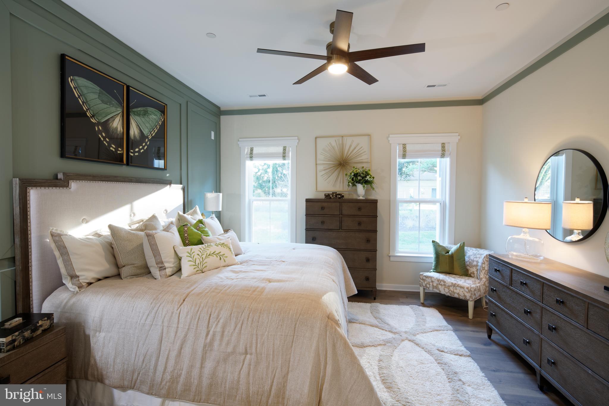 1007 Champlain Court Trappe, MD 21673 - Photo 10 of 54 a bedroom with a bed a chandelier and a dresser