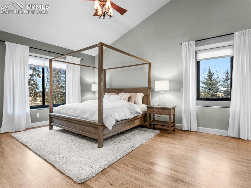 133 Matthew Road Divide, CO 80814 - Photo 12 of 37 a bedroom with a bed lamp and a large window