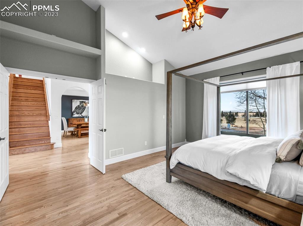 133 Matthew Road Divide, CO 80814 - Photo 13 of 37 a bedroom with a large bed and a chandelier