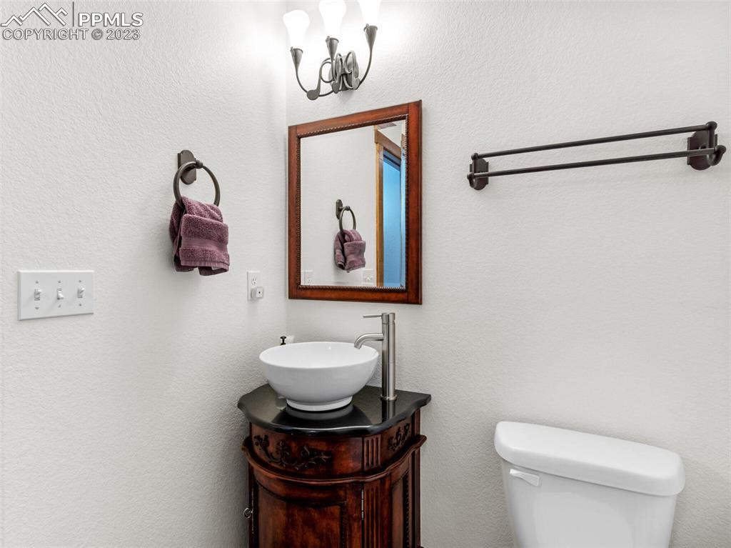 133 Matthew Road Divide, CO 80814 - Photo 26 of 37 a bathroom with a toilet a sink and mirror