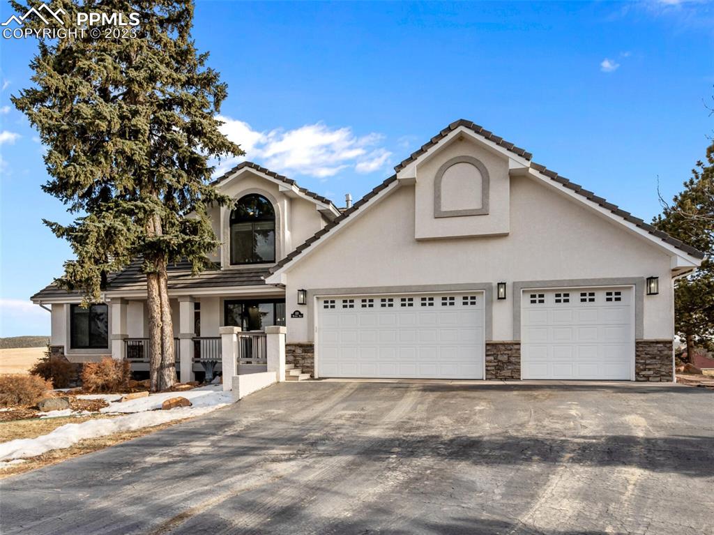 133 Matthew Road Divide, CO 80814 - Photo 30 of 37 a front view of a house with a yard and garage