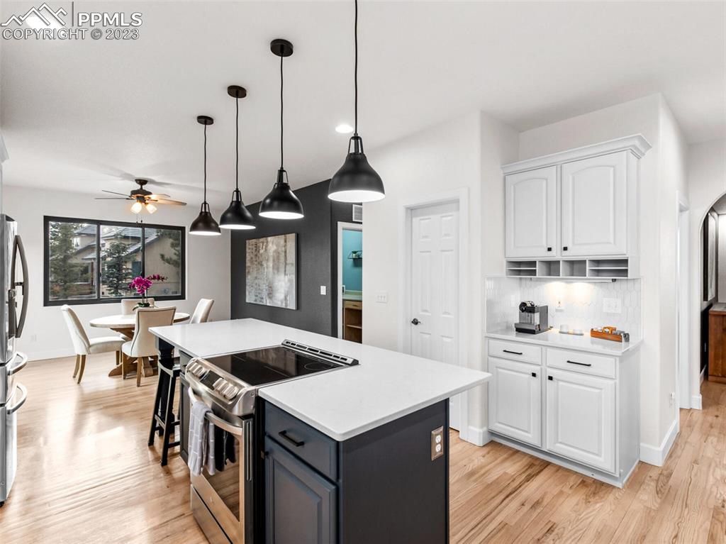 133 Matthew Road Divide, CO 80814 - Photo 3 of 37 a kitchen that has a lot of cabinets in it and wooden floors