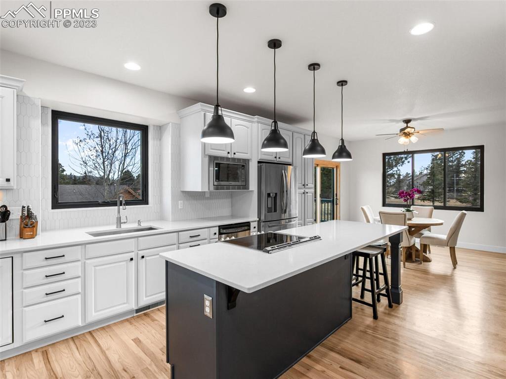 133 Matthew Road Divide, CO 80814 - Photo 5 of 37 a kitchen with a sink stove and cabinets