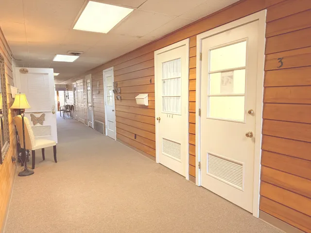 a view of a hallway with furniture and a window