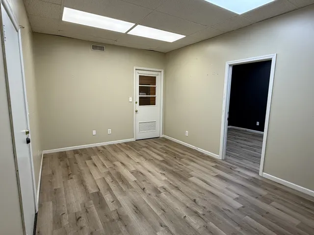 an empty room with wooden floor and closet