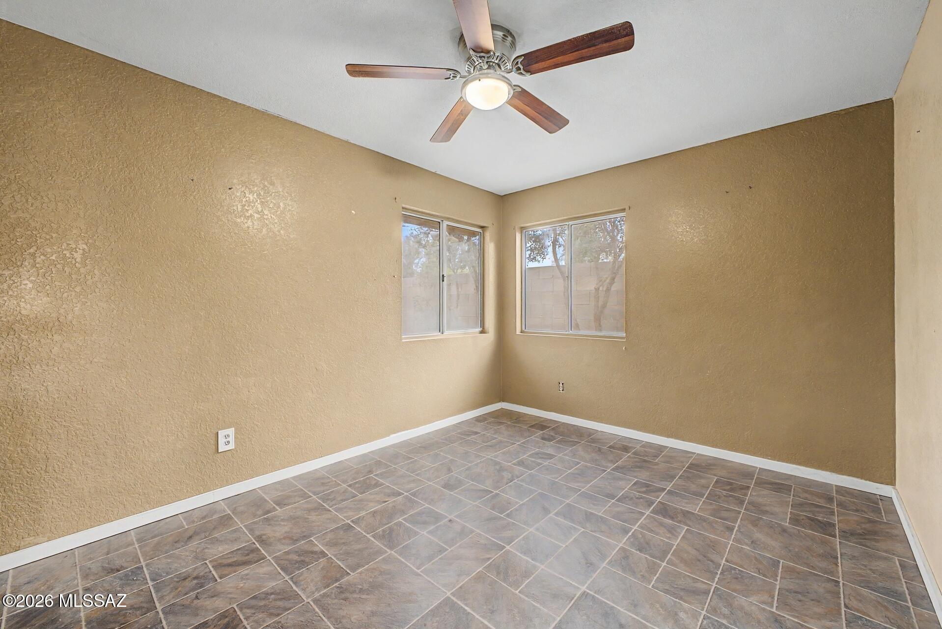 9810 East Stonehaven Way Tucson, AZ 85747 - Photo 25 of 27 a view of an empty room with a window
