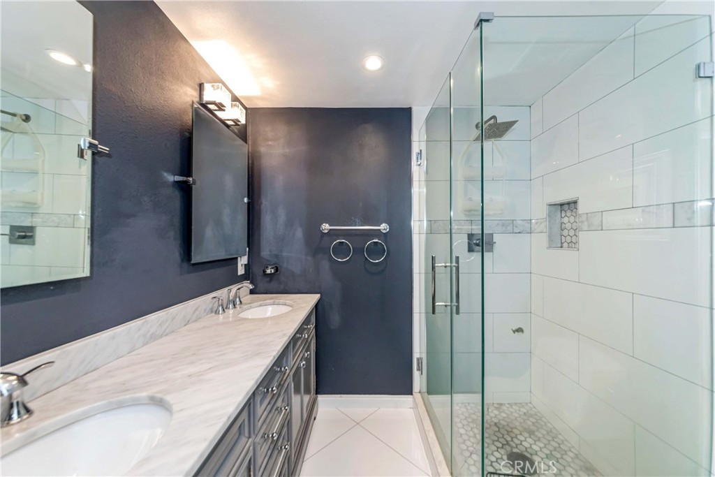 2175 Calavera Place Fullerton, CA 92833 - Photo 26 of 51 a bathroom with a double vanity sink a mirror and shower