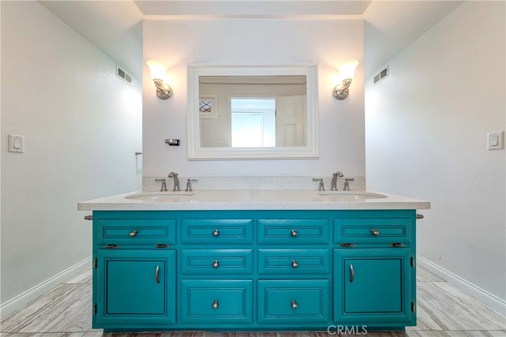 2175 Calavera Place Fullerton, CA 92833 - Photo 34 of 51 a bathroom with a sink mirror and cabinets