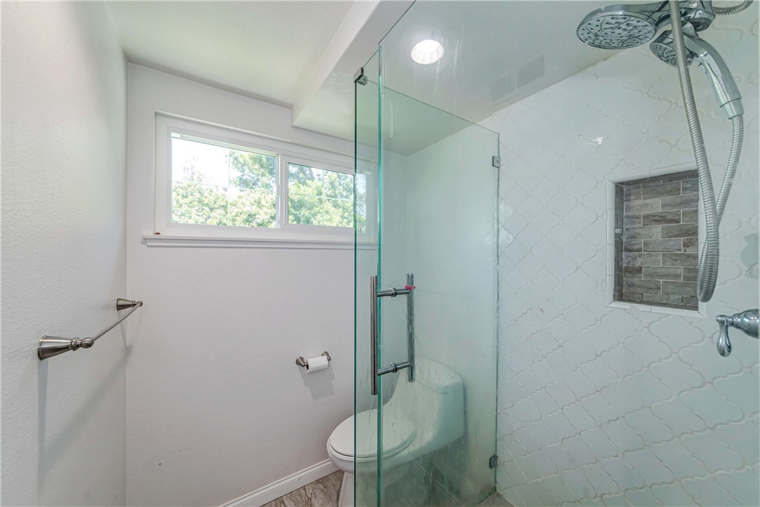 2175 Calavera Place Fullerton, CA 92833 - Photo 37 of 51 a bathroom with a shower a toilet and a window