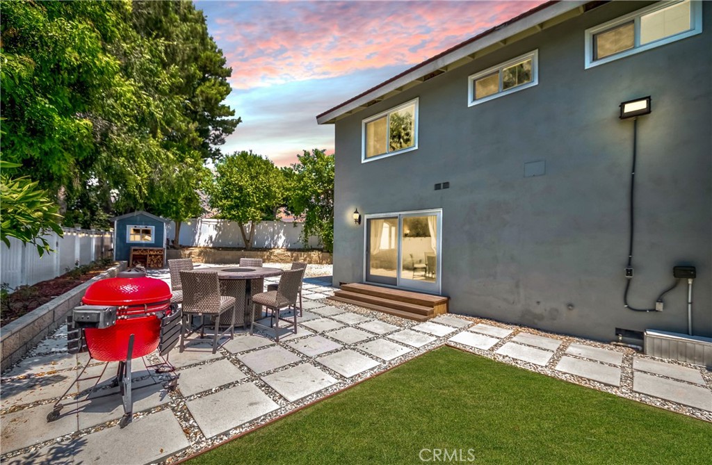 2175 Calavera Place Fullerton, CA 92833 - Photo 42 of 51 a view of a backyard with table and chairs and a barbeque
