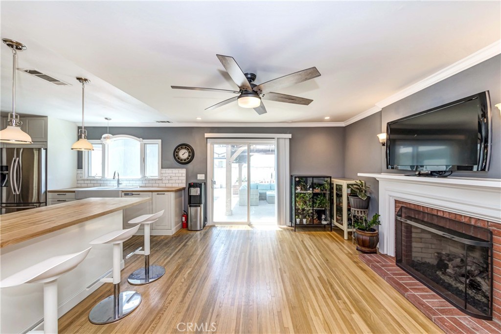 2175 Calavera Place Fullerton, CA 92833 - Photo 10 of 51 a kitchen with sink a microwave a stove and white cabinets with wooden floor