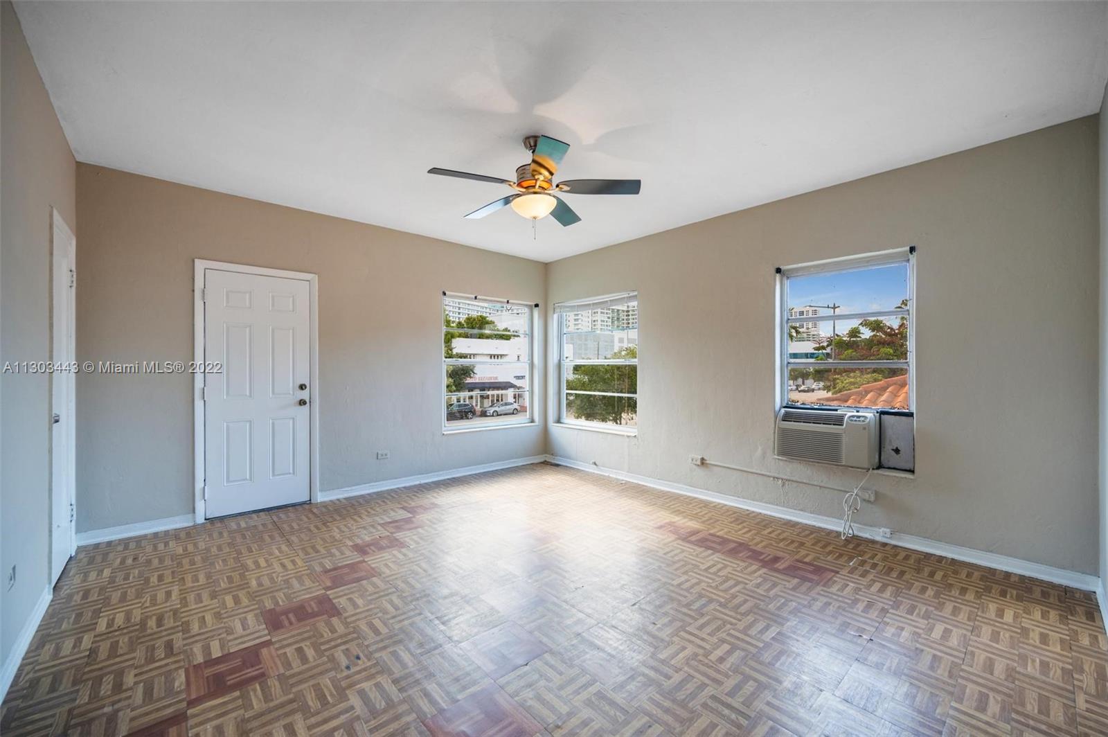 825 Alton Road, Unit 7 Miami Beach, FL 33139 - Photo 2 of 8 a view of an empty room with a window