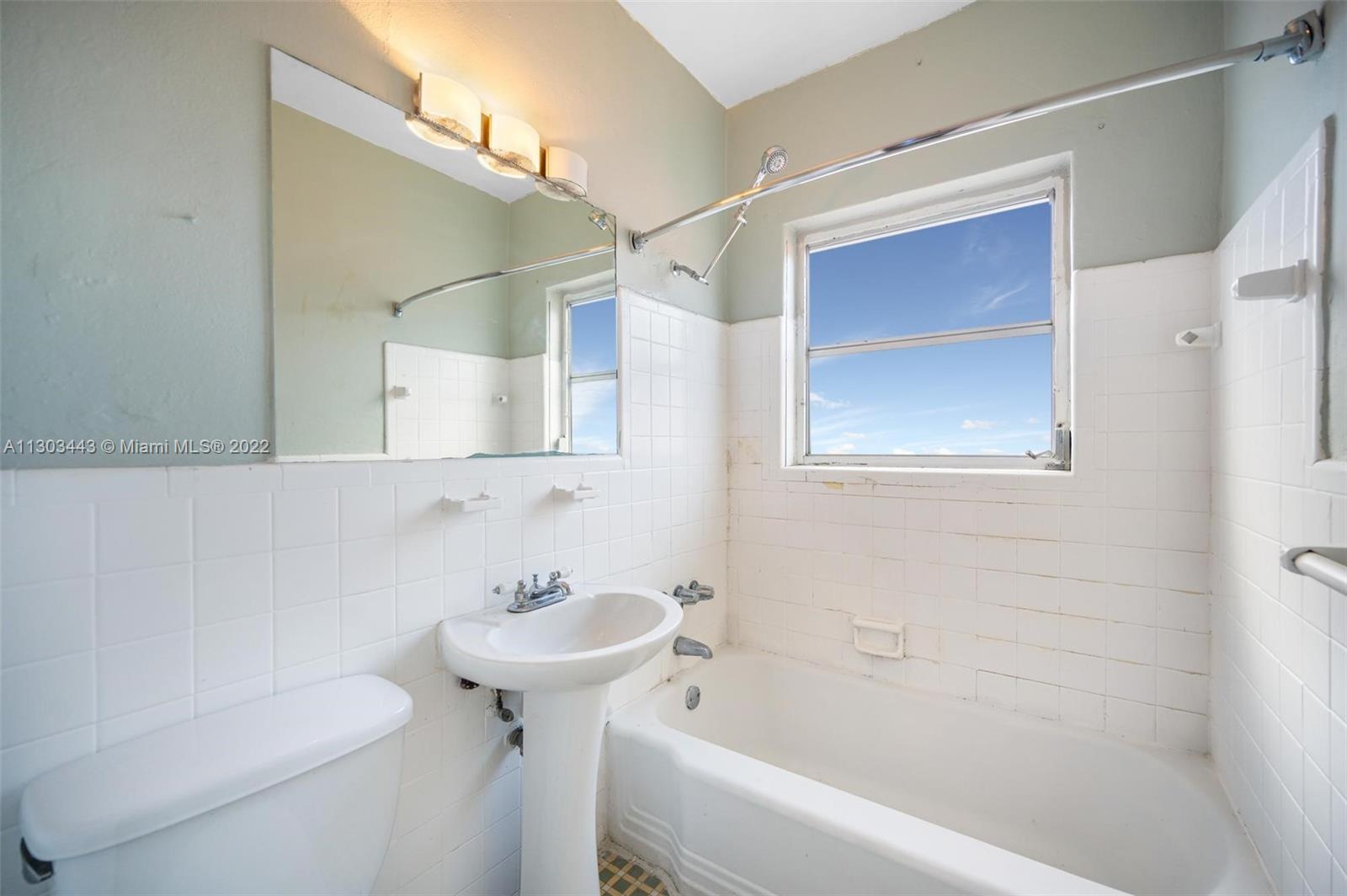 825 Alton Road, Unit 7 Miami Beach, FL 33139 - Photo 8 of 8 a bathroom with a sink toilet and shower