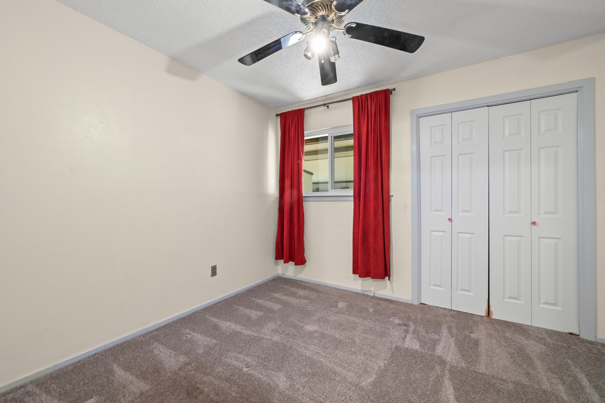 10504 Hard Rock Road Austin, TX 78750 - Photo 21 of 28 A well-lit bedroom features plush carpeting and convenient bi-fold closet doors.
