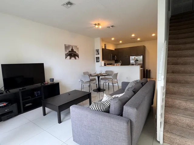 a living room with furniture and a flat screen tv