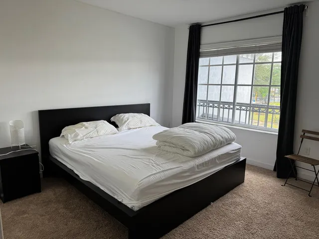 a bedroom with a bed and a window