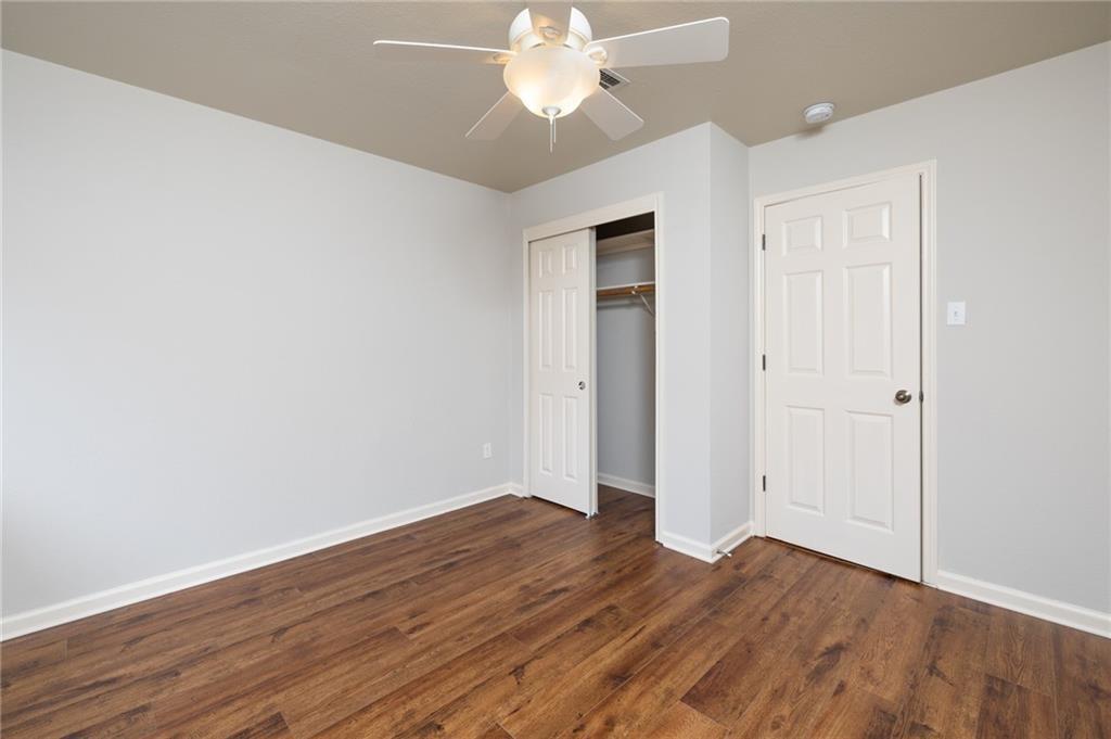 4526 Corran Ferry Loop Austin, TX 78749 - Photo 22 of 25 Rich wood-inspired floors and neutral walls create a versatile canvas ready for personalization.
