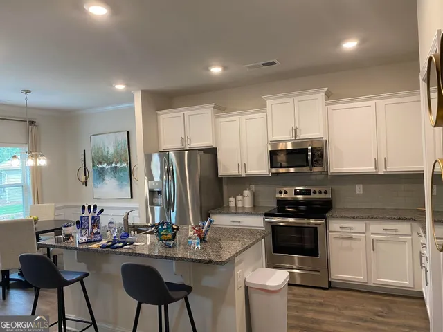 a kitchen with stainless steel appliances a stove sink microwave and cabinets