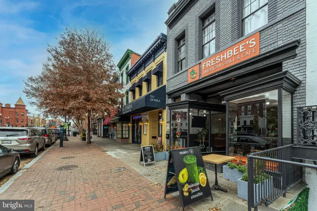 a view of a building with sitting area and furniture