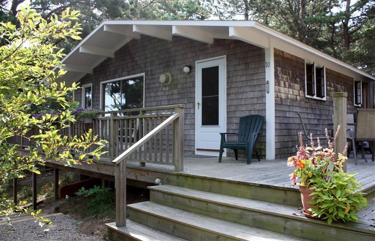 30 Fox Island Road, Unit 10D Wellfleet, MA 02667 - Photo 1 of 17 a front view of a house with plants