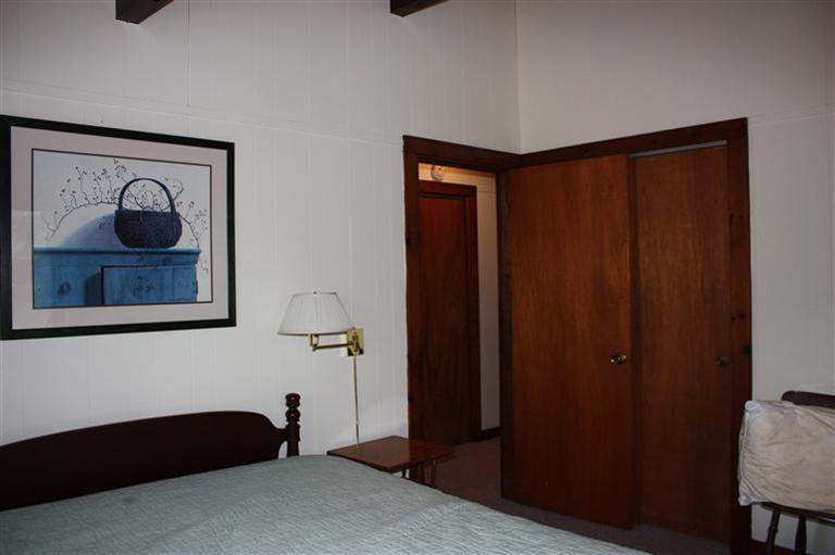 30 Fox Island Road, Unit 10D Wellfleet, MA 02667 - Photo 14 of 17 a bedroom with a bed and a painting on the wall