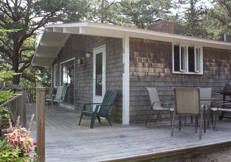 30 Fox Island Road, Unit 10D Wellfleet, MA 02667 - Photo 3 of 17 a view of a patio with table and chairs and potted plants