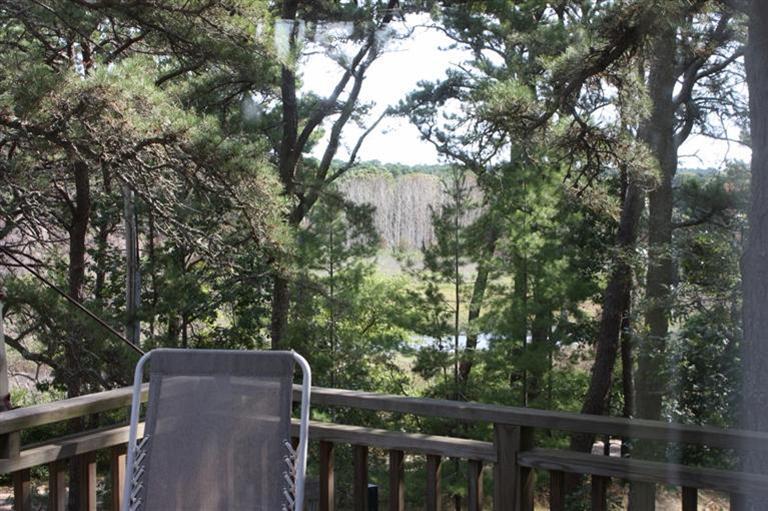 30 Fox Island Road, Unit 10D Wellfleet, MA 02667 - Photo 5 of 17 a view of a wooden fence and trees in the background