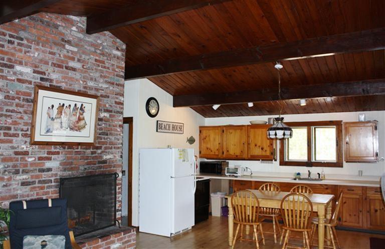 30 Fox Island Road, Unit 10D Wellfleet, MA 02667 - Photo 6 of 17 a kitchen with stainless steel appliances kitchen island granite countertop a refrigerator and a stove top oven