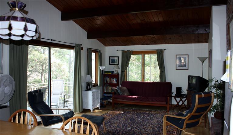 30 Fox Island Road, Unit 10D Wellfleet, MA 02667 - Photo 7 of 17 a living room with furniture a window and a flat screen tv