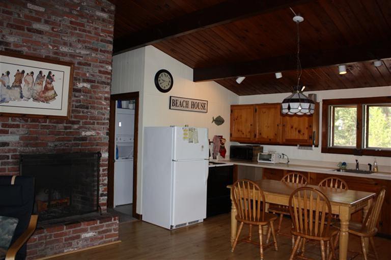 30 Fox Island Road, Unit 10D Wellfleet, MA 02667 - Photo 9 of 17 a kitchen with stainless steel appliances granite countertop a refrigerator a stove and a microwave with wooden floor