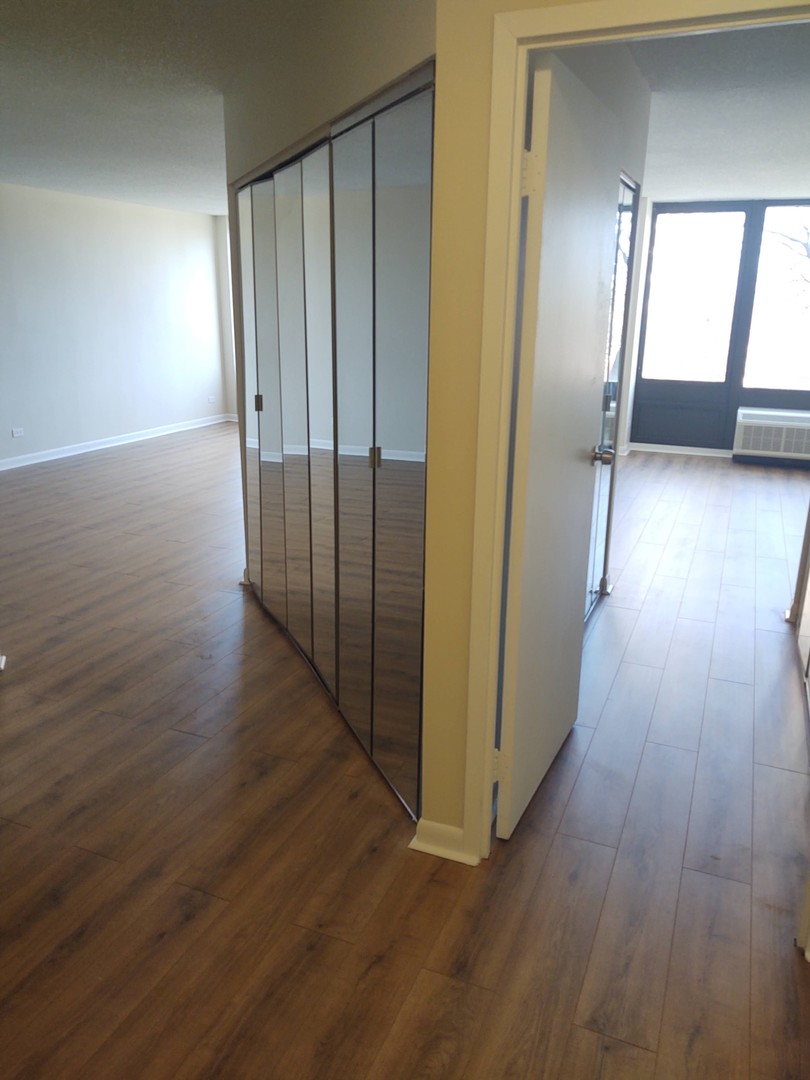 5320 North Sheridan Road, Unit 407 Chicago, IL 60640 - Photo 5 of 26 a view of a hallway with wooden floor