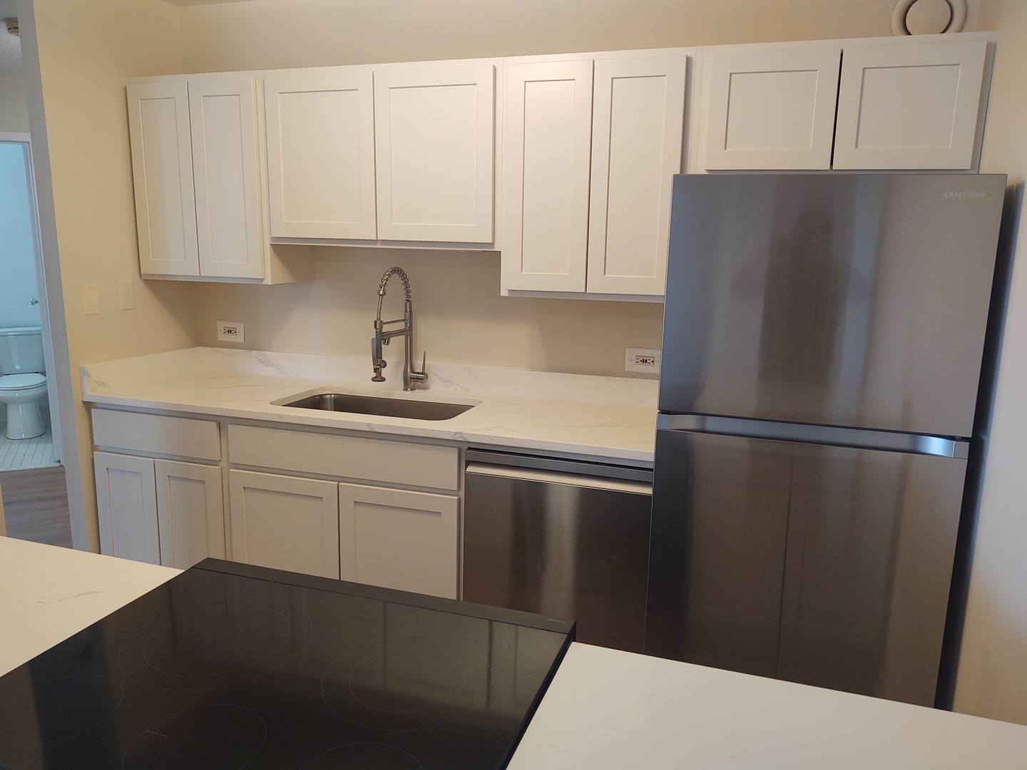 5320 North Sheridan Road, Unit 407 Chicago, IL 60640 - Photo 6 of 26 a kitchen with a refrigerator sink and cabinets