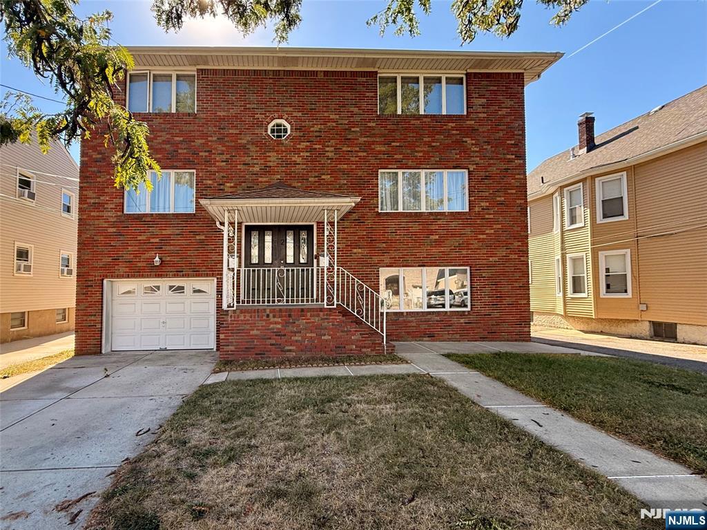front view of a brick house with a yard