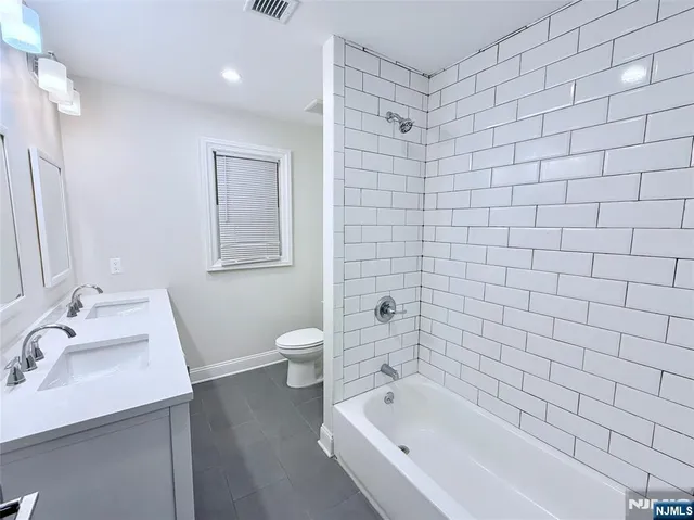 a bathroom with a bathtub and sink