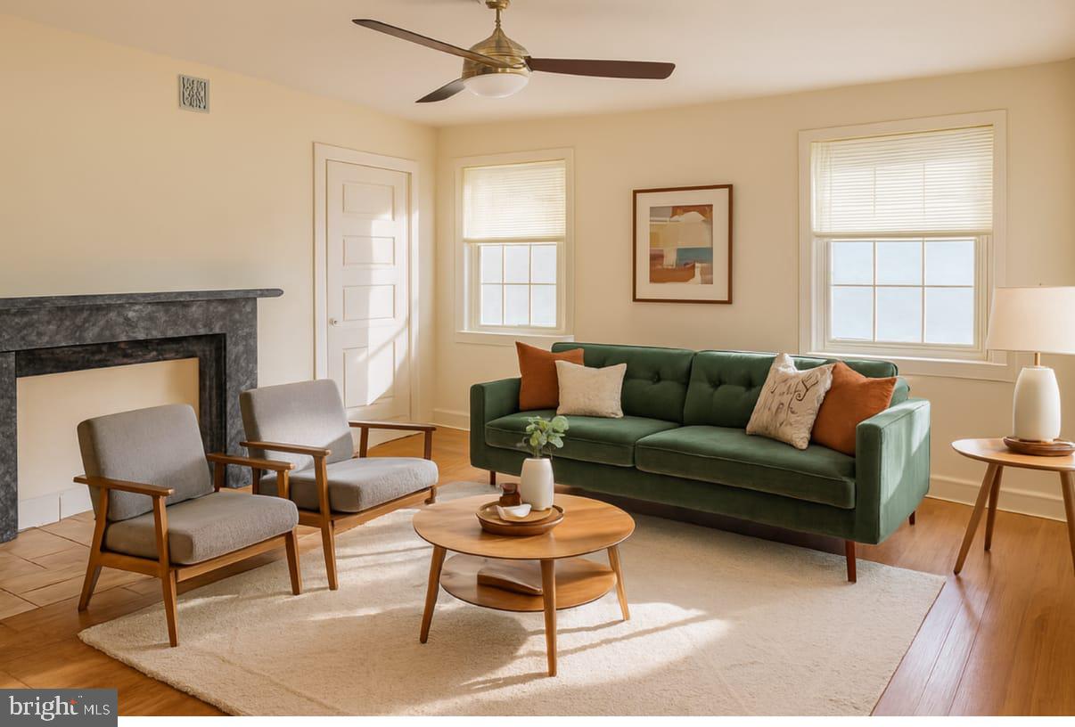 312 South 12th Street, Unit 3F Philadelphia, PA 19107 - Photo 2 of 4 a living room with furniture a large window and a fireplace
