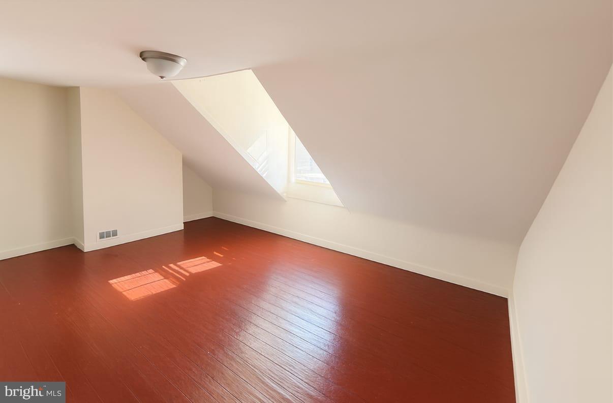 312 South 12th Street, Unit 3F Philadelphia, PA 19107 - Photo 3 of 4 a view of an empty room with wooden floor and a window