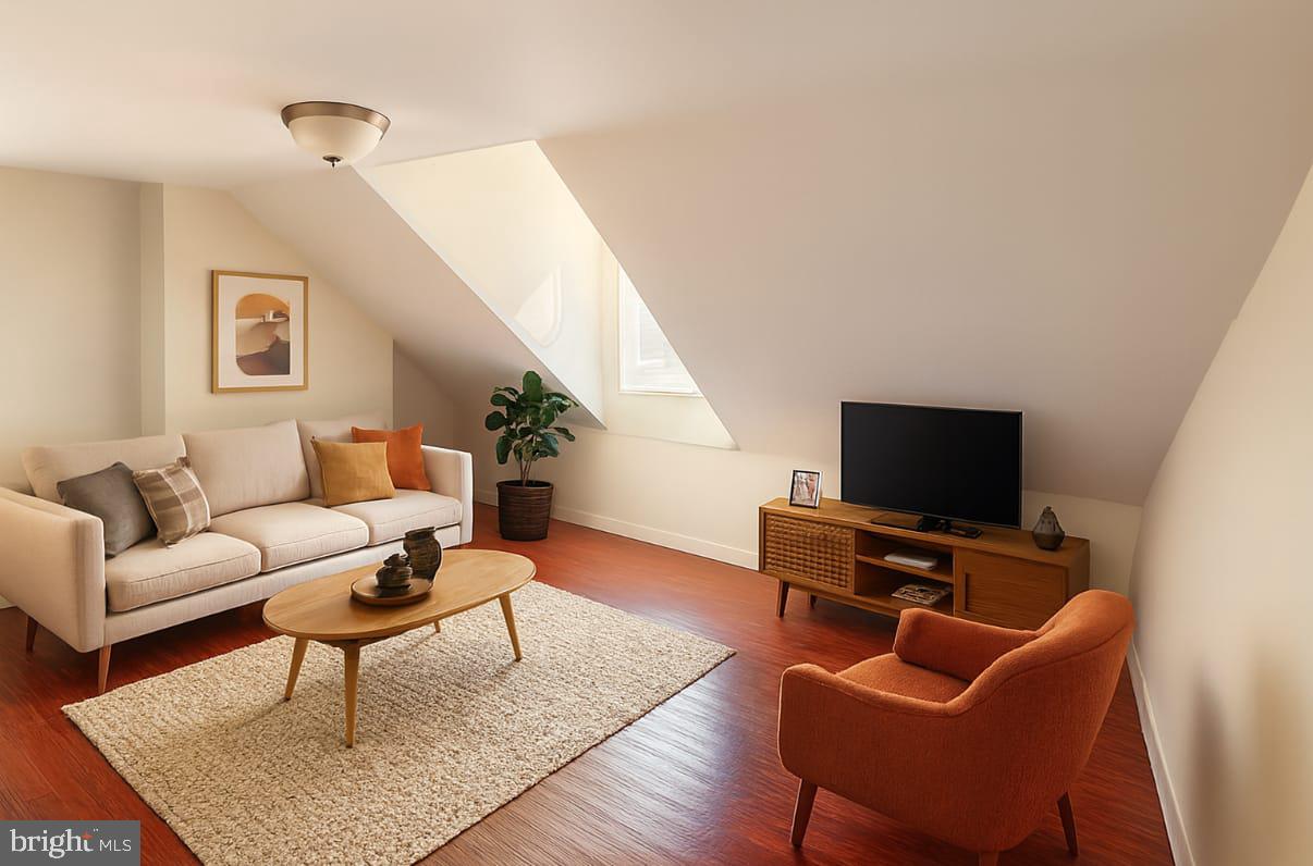 312 South 12th Street, Unit 3F Philadelphia, PA 19107 - Photo 4 of 4 a living room with furniture and a flat screen tv