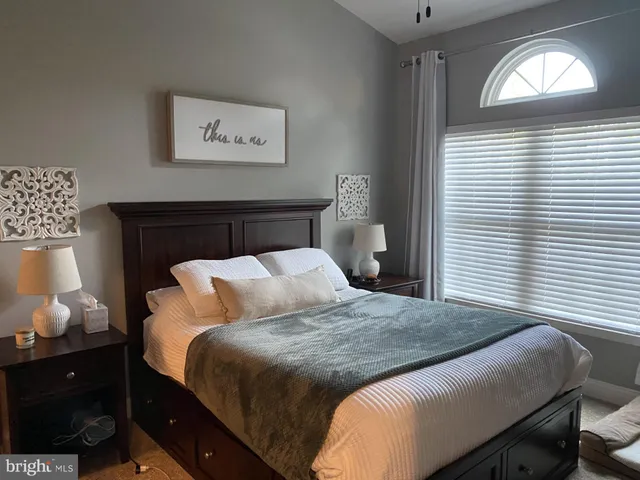 a bedroom with a bed and window