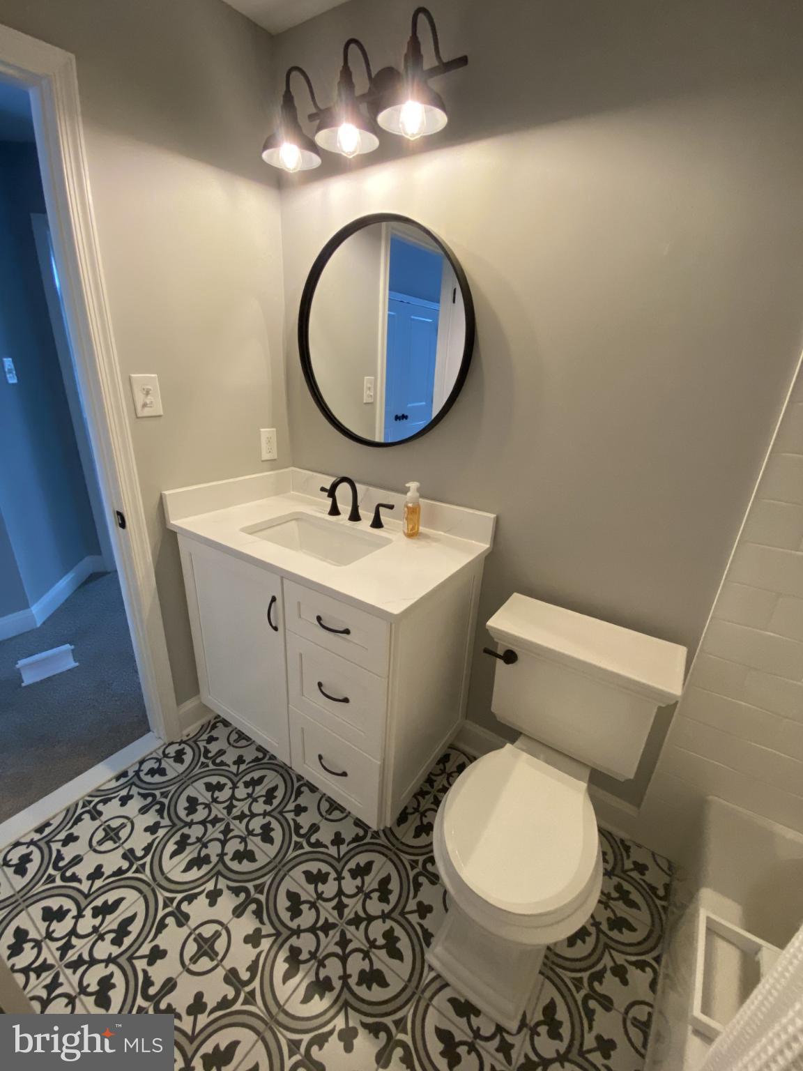 424 Trumbull Court Newtown, PA 18940 - Photo 18 of 21 a bathroom with a toilet sink and mirror