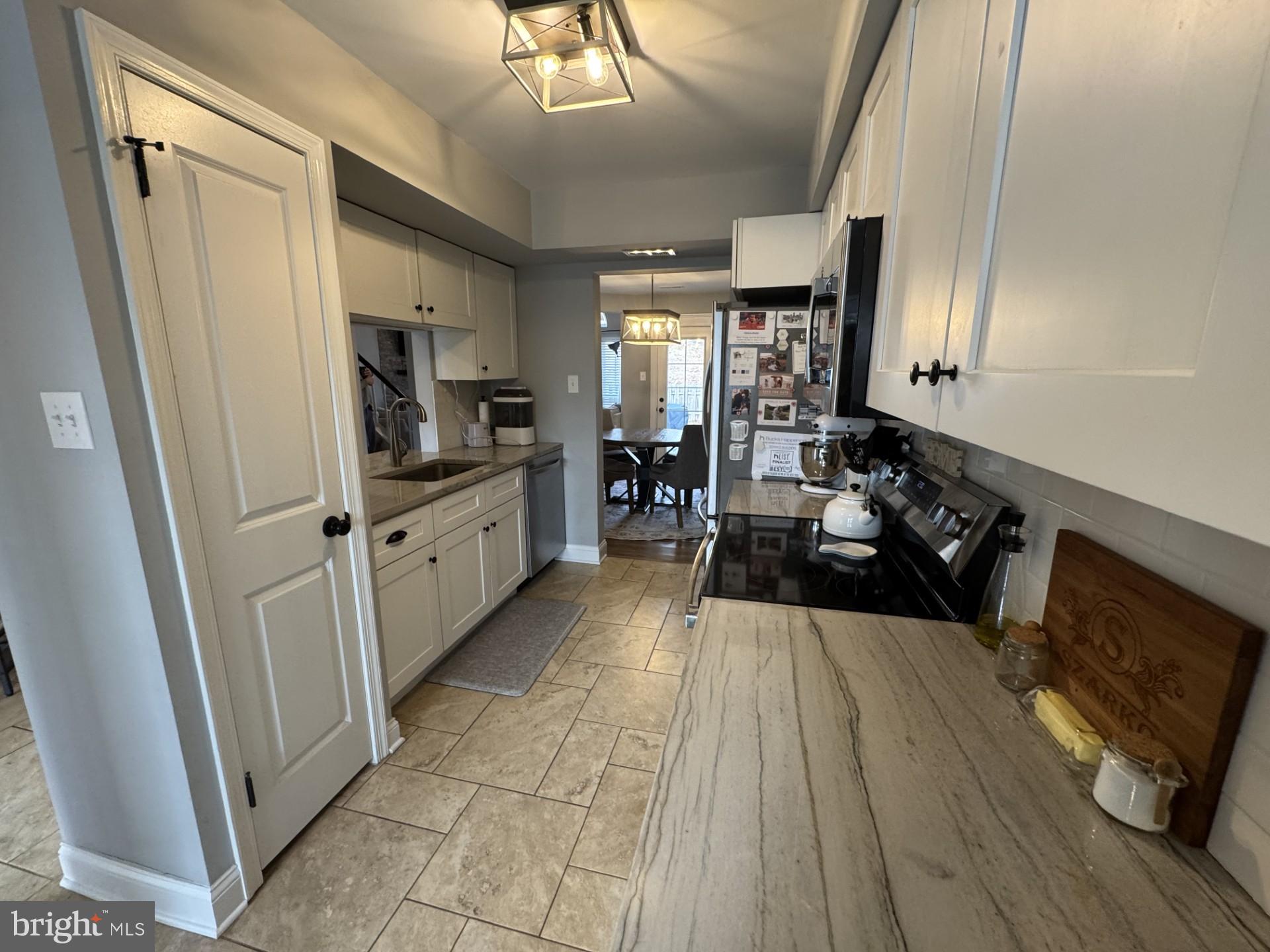 424 Trumbull Court Newtown, PA 18940 - Photo 8 of 21 a large white kitchen with cabinets a sink a stove and a refrigerator