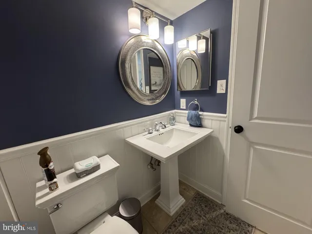a bathroom with a toilet sink and mirror