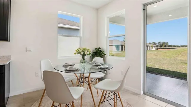 a dining room with furniture and wooden floor